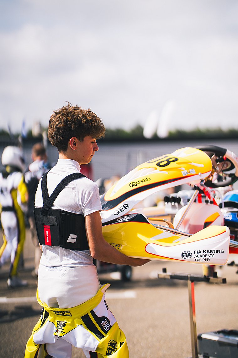 Stavros Tsotsos Francia, FIA Karting Academy Trophy Junior, Genk 2026 Stavros Tsotsos Francia trägt sein gelbes Kart im Fahrerlager der FIA Karting Academy Trophy zum Einsatzbereich.
